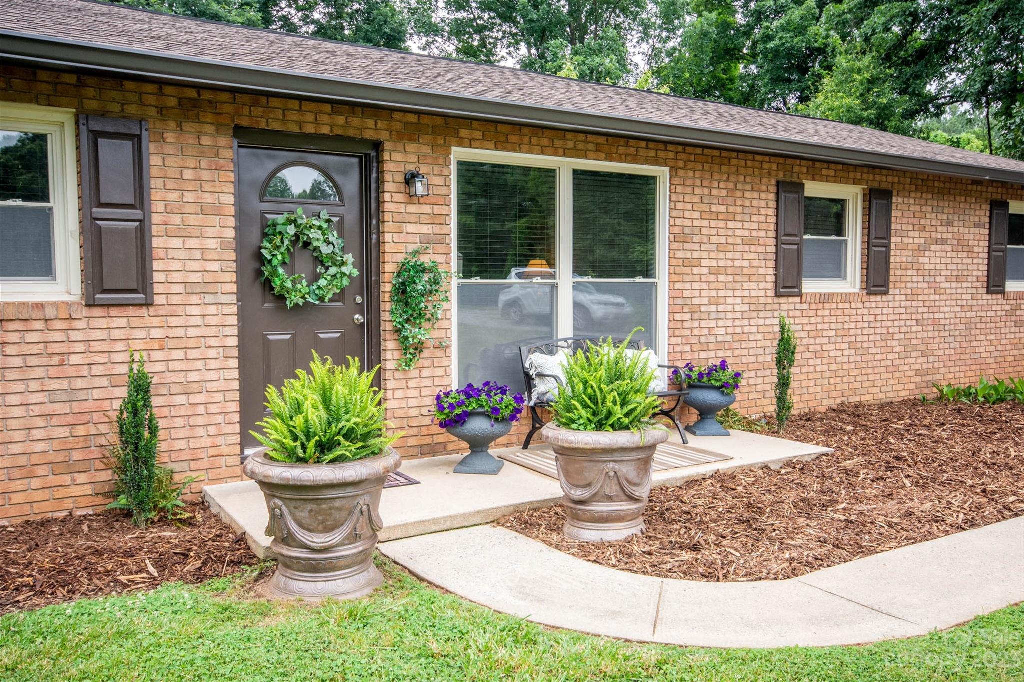 357 Pop Davis Road Taylorsville, NC 28681 - Photo 5 of 45 a view of a small house with potted plants