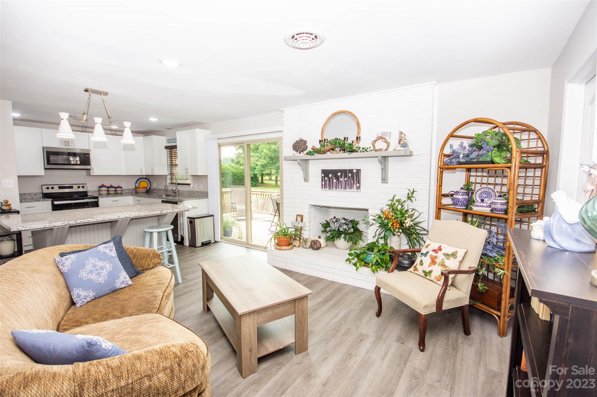 357 Pop Davis Road Taylorsville, NC 28681 - Photo 10 of 45 a living room with furniture a fireplace and a large window