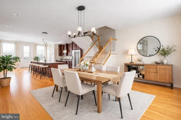 a dining room with furniture and wooden floor