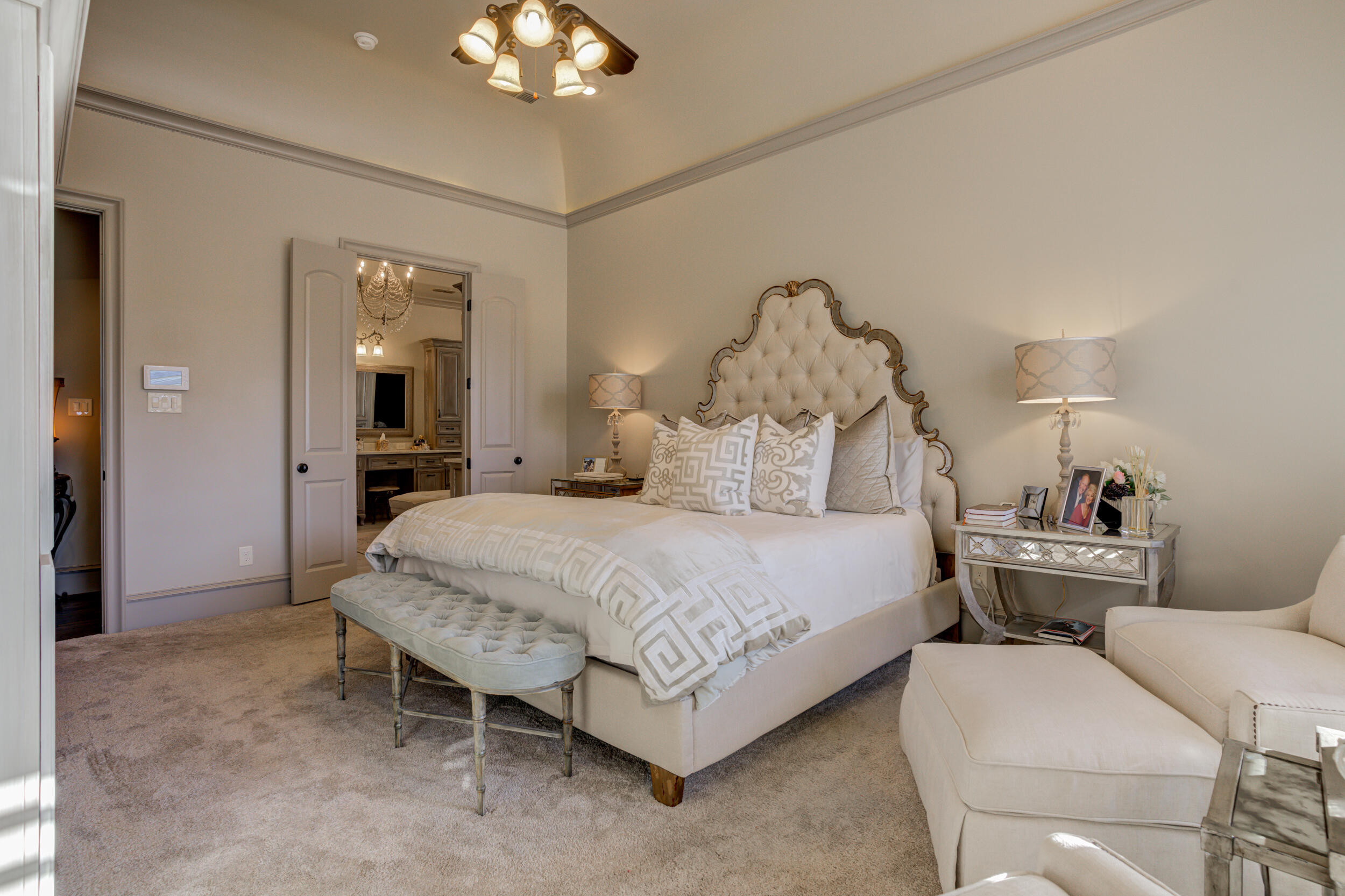4815 119th Street Lubbock, TX 79424 - Photo 29 of 74 a spacious bedroom with a bed and a chandelier