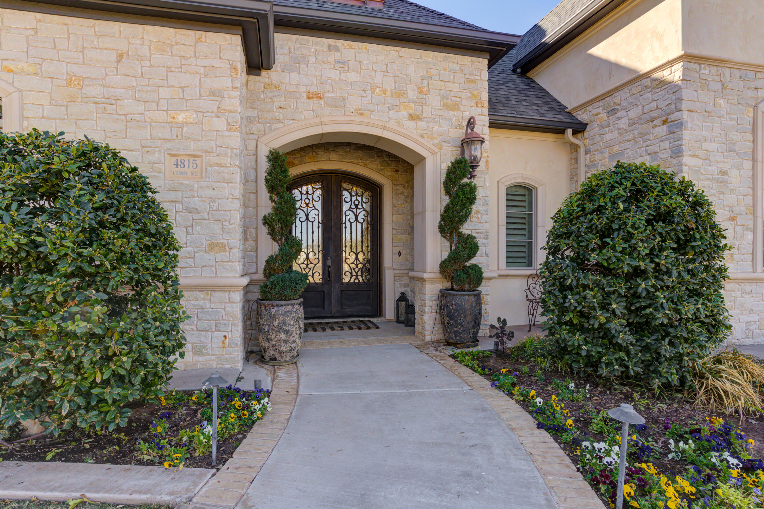 4815 119th Street Lubbock, TX 79424 - Photo 3 of 74 a front view of a house with potted plants