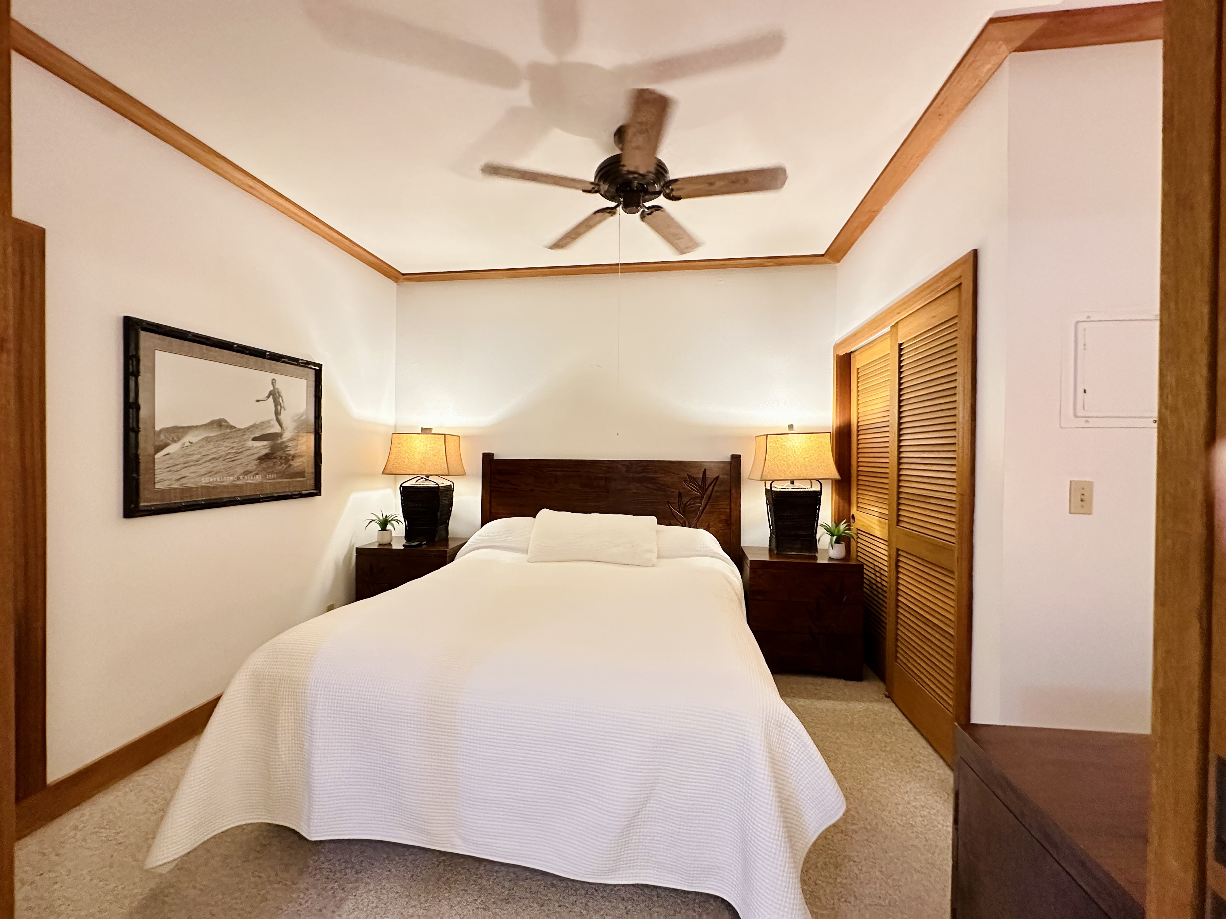 2253 Poipu Road, Unit 446 Koloa, HI 96756 - Photo 2 of 16 a bedroom with a bed and a chandelier