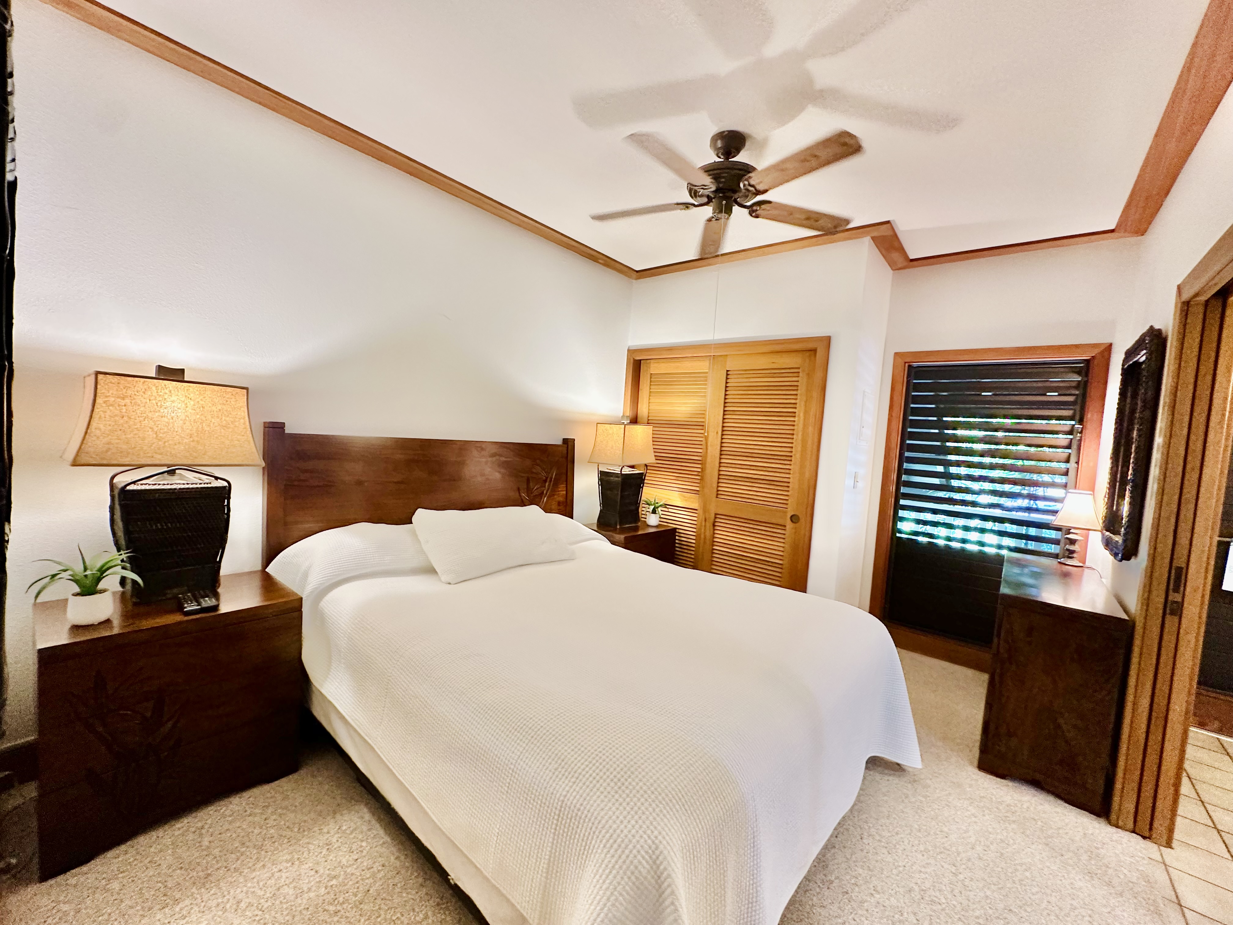 2253 Poipu Road, Unit 446 Koloa, HI 96756 - Photo 3 of 16 a bedroom with a large bed and a flat tv screen on dresser