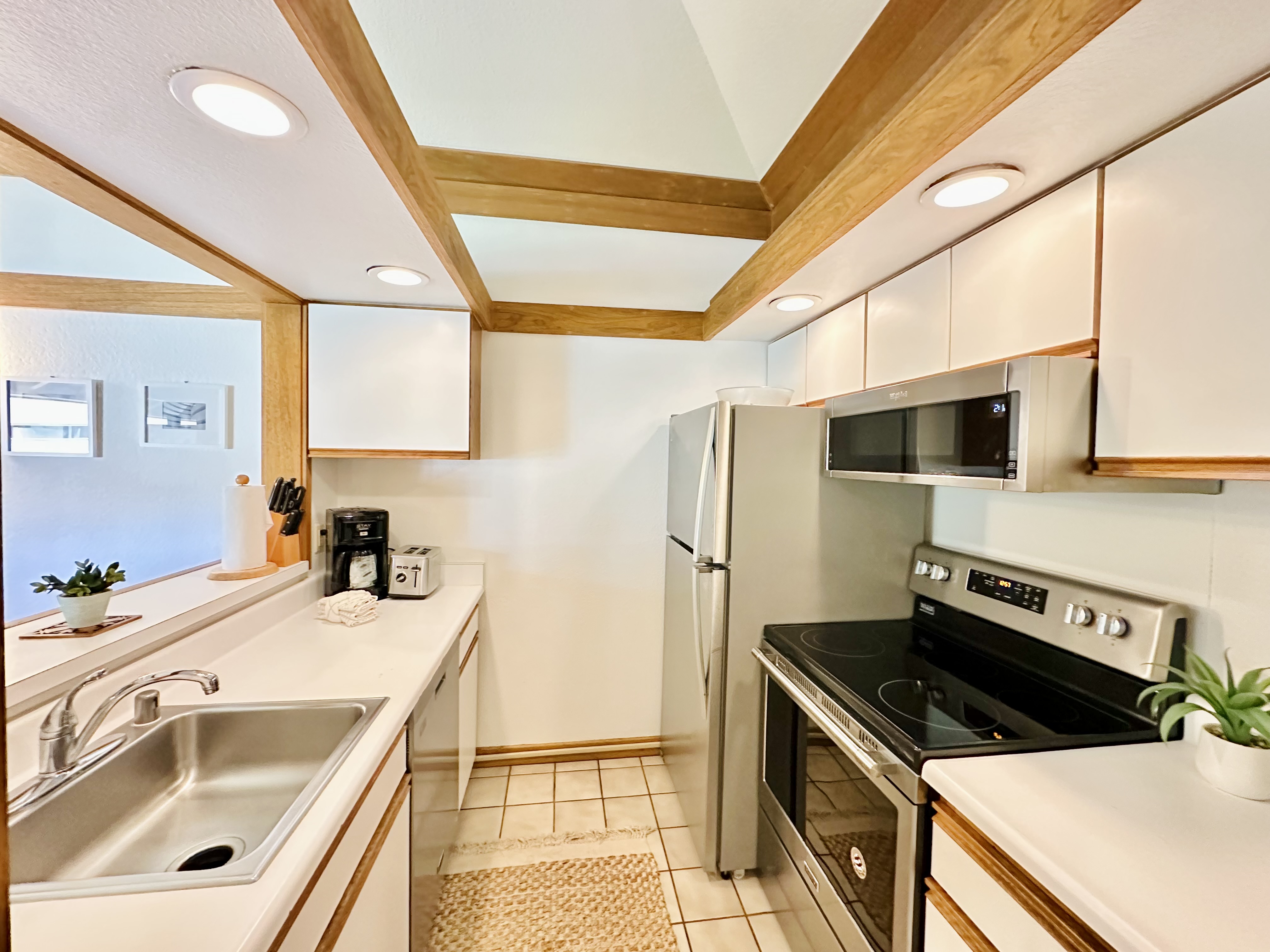 2253 Poipu Road, Unit 446 Koloa, HI 96756 - Photo 5 of 16 a kitchen that has a sink a stove top oven and refrigerator