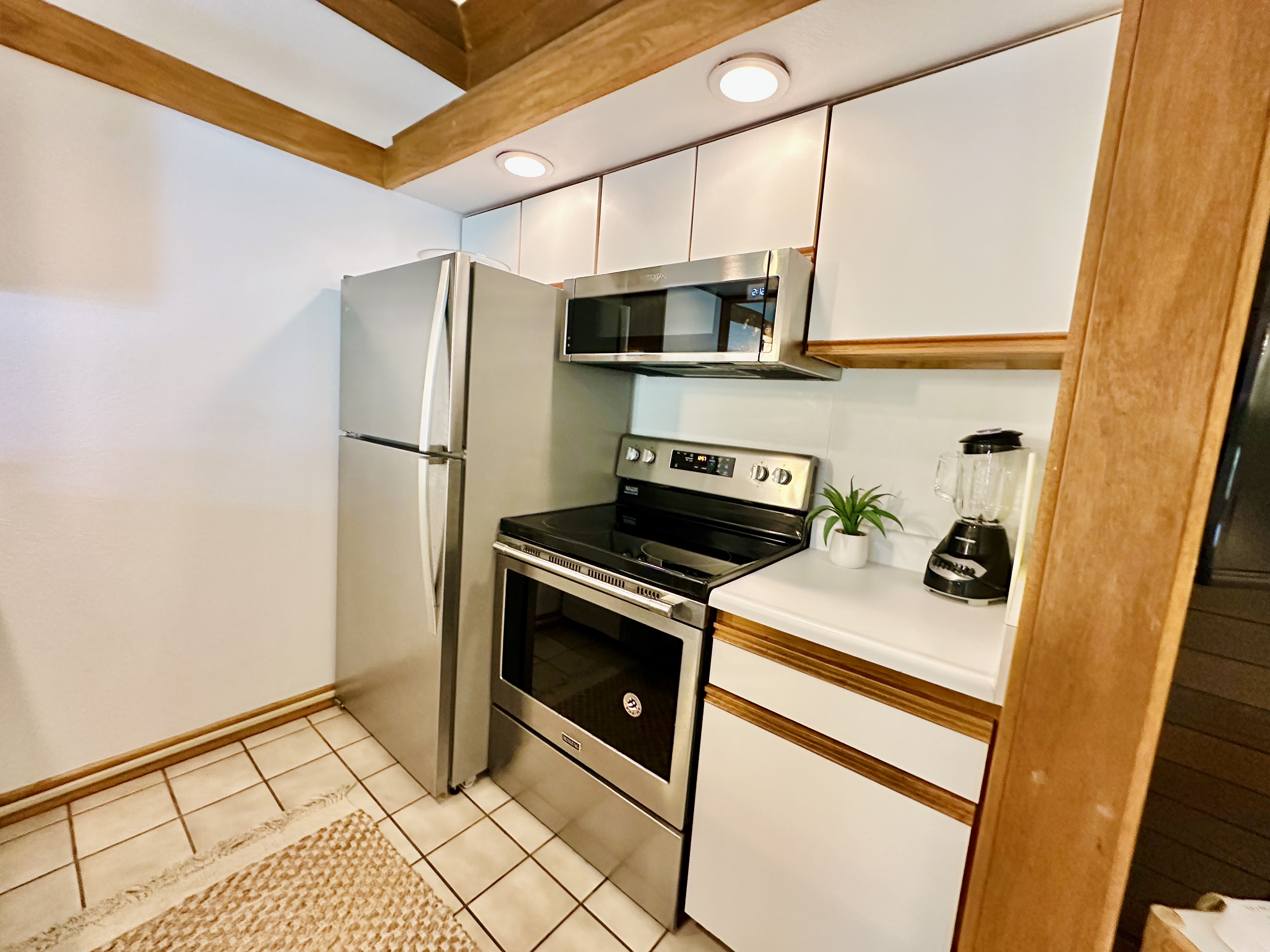 2253 Poipu Road, Unit 446 Koloa, HI 96756 - Photo 6 of 16 a kitchen with stainless steel appliances a stove microwave and a refrigerator