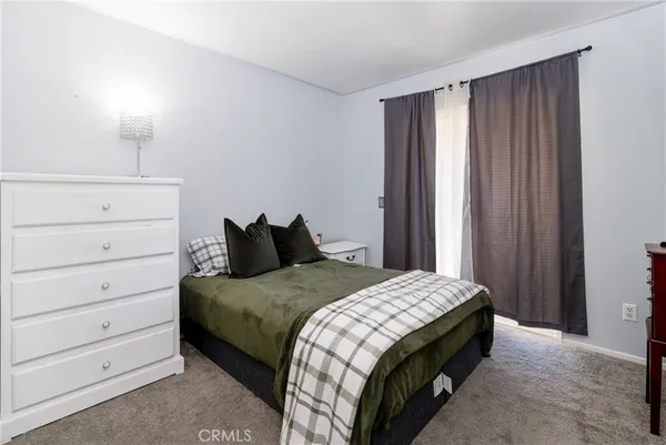 a bedroom with a bed and a mirror