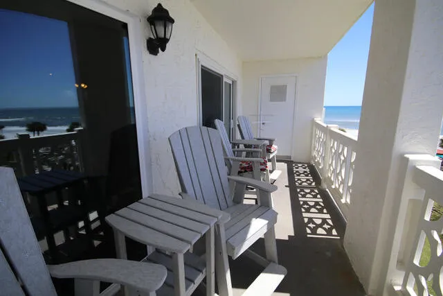 a view of a livingroom with furniture a rug and wooden floor