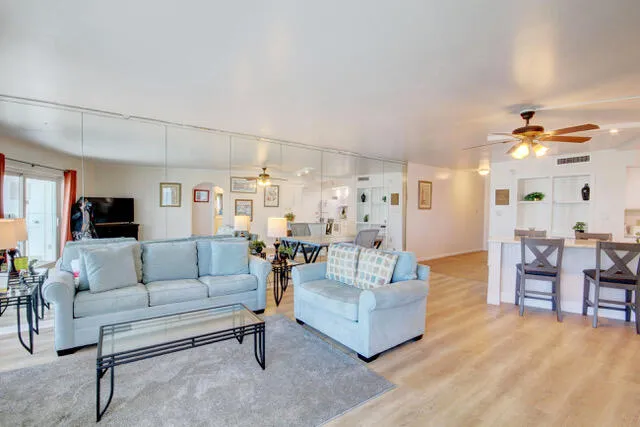 a living room with furniture and view of kitchen