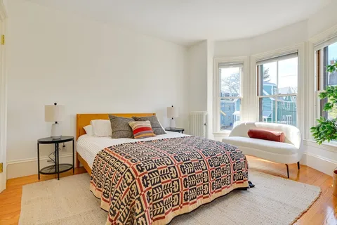 a bedroom with a bed and glass window