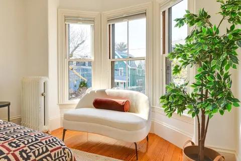 a bedroom with a bed and a potted plant