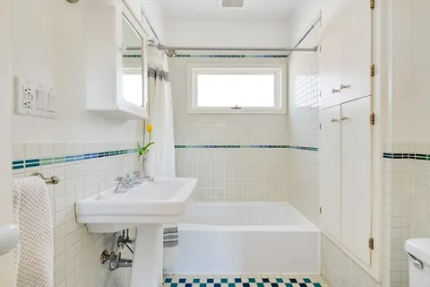 a bathroom with a sink a mirror and a bathtub