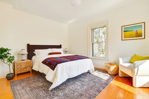 a bedroom with a bed and lamp