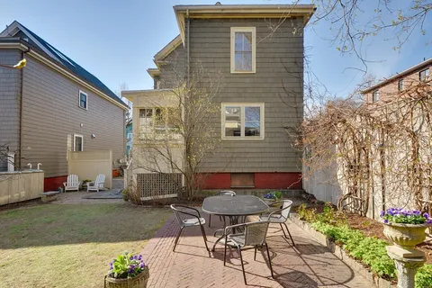 a backyard of a house with outdoor seating