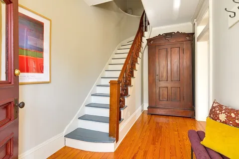 a view of entryway with wooden floor and stairs