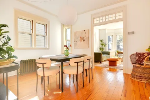 a view of a dining room with furniture and wooden floor