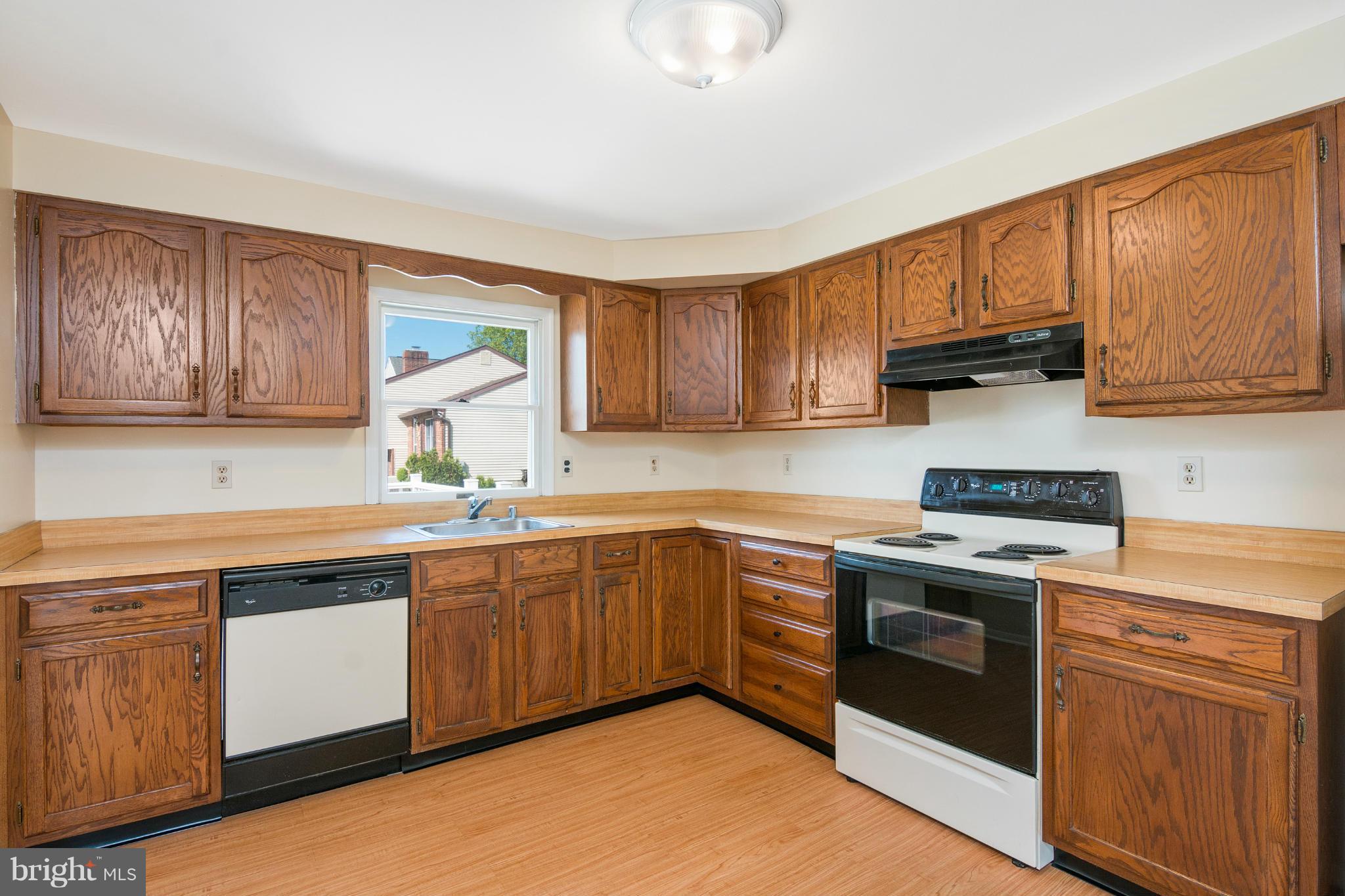 9005 Throgmorton Road Baltimore, MD 21234 - Photo 13 of 30 a kitchen with a sink stove top oven and cabinets