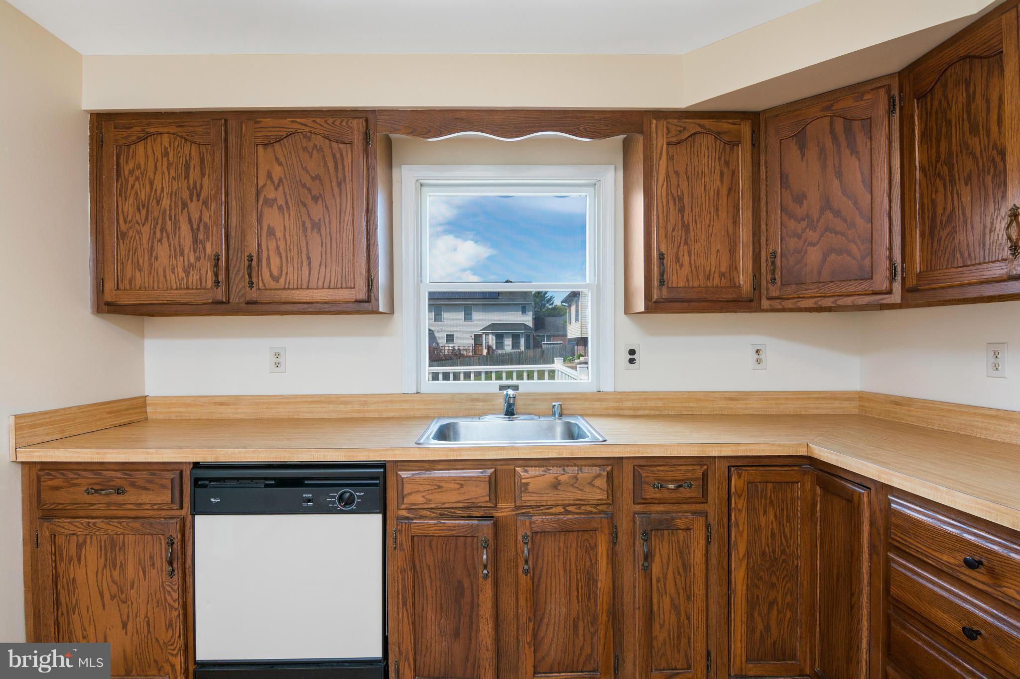 9005 Throgmorton Road Baltimore, MD 21234 - Photo 14 of 30 a kitchen with stainless steel appliances granite countertop a sink stove and cabinets