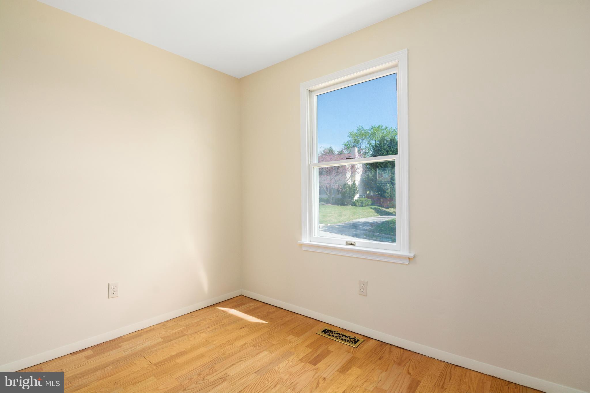 9005 Throgmorton Road Baltimore, MD 21234 - Photo 19 of 30 a view of a small space with wooden floor and a window