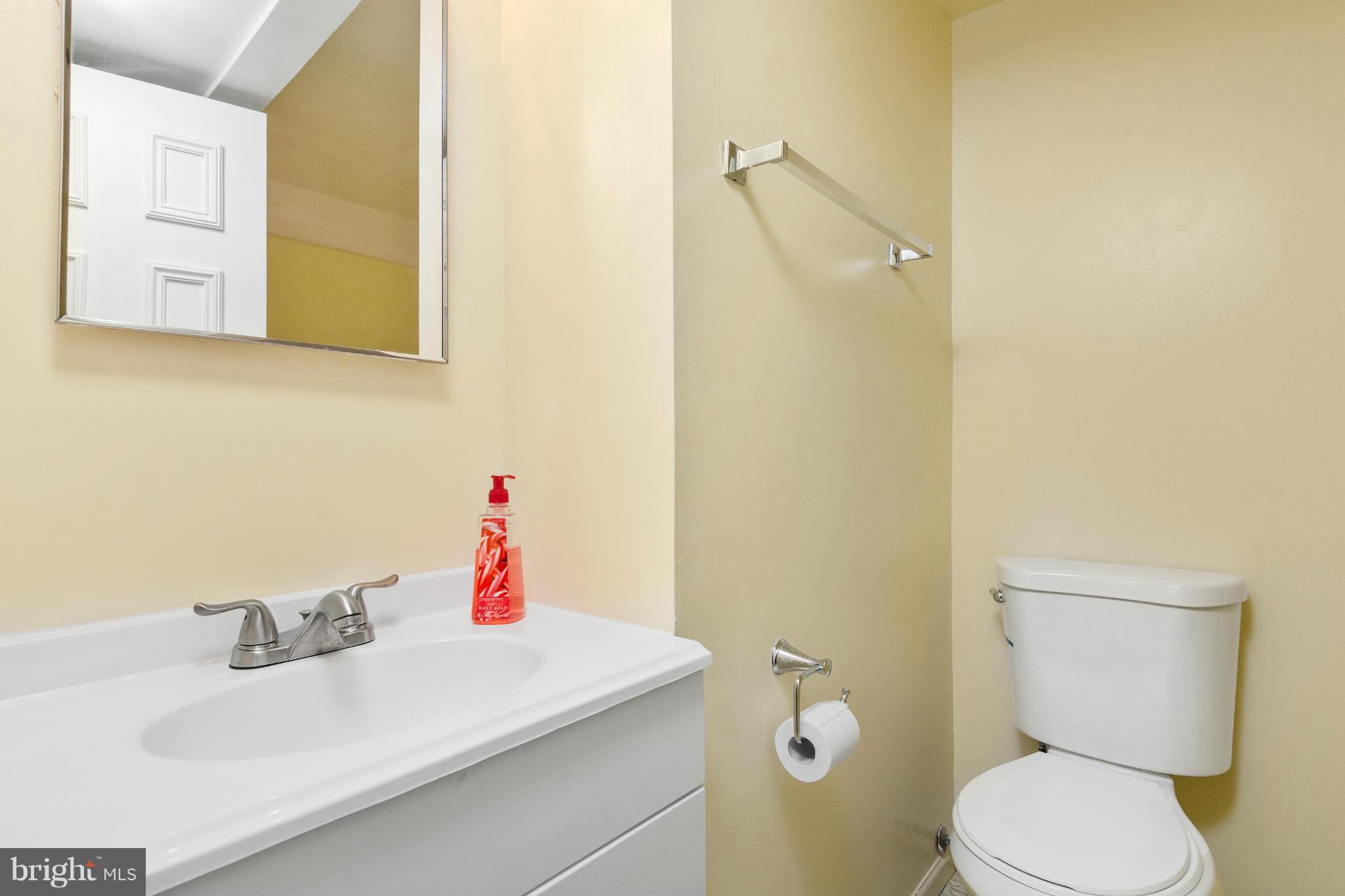 9005 Throgmorton Road Baltimore, MD 21234 - Photo 27 of 30 a bathroom with a sink mirror vanity and toilet
