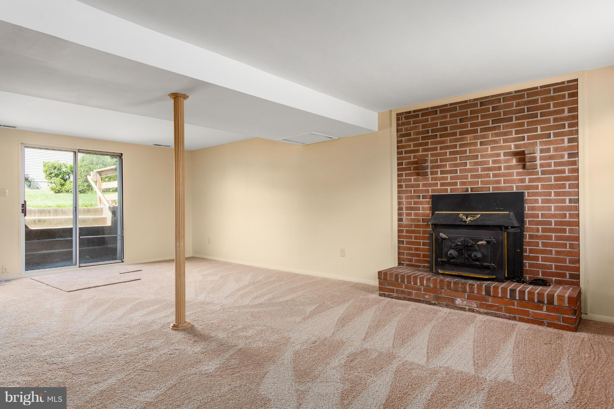 9005 Throgmorton Road Baltimore, MD 21234 - Photo 30 of 30 a view of an empty room with a fireplace and a window