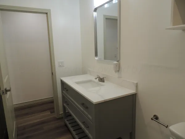 a bathroom with a sink vanity and a mirror