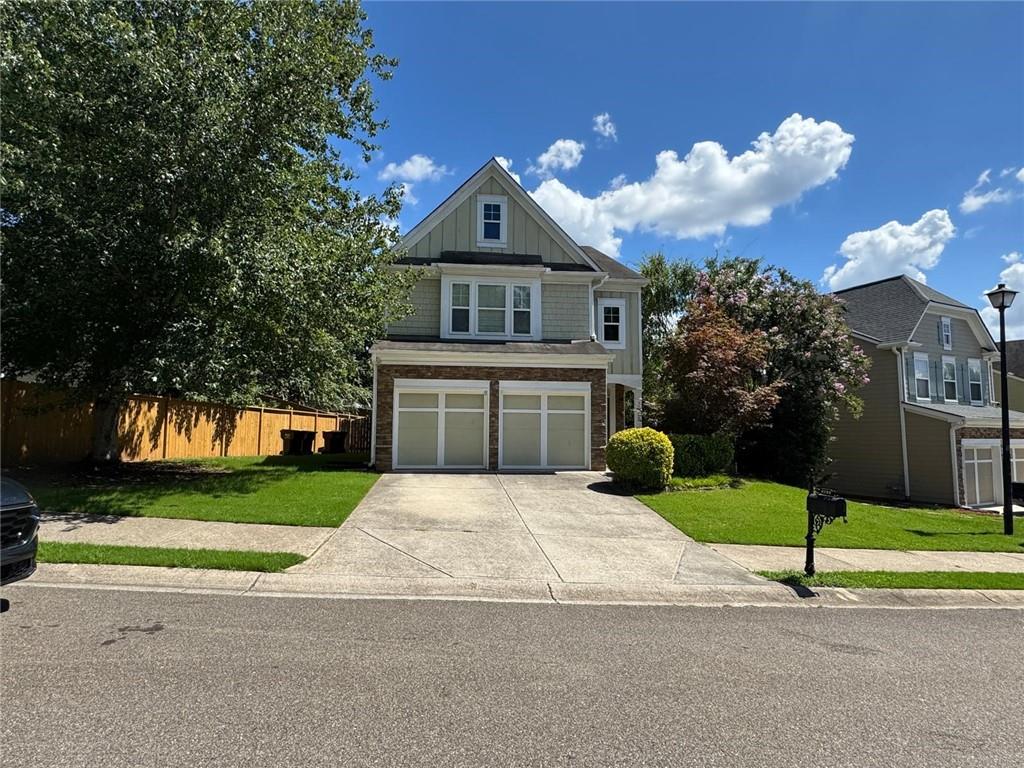 a front view of house with yard and green space