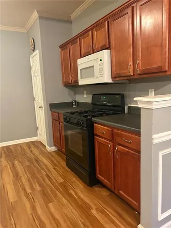 a kitchen with stainless steel appliances granite countertop a stove a microwave and a refrigerator