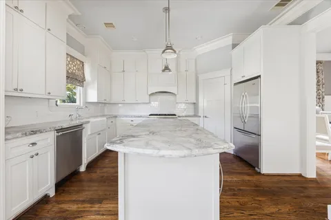 a kitchen with a sink stove and refrigerator