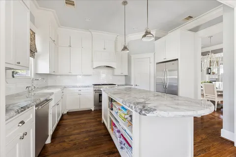 a kitchen with a stove sink and cabinets