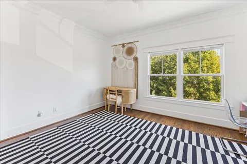 a view of a room with wooden floor and a window
