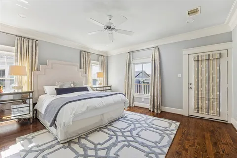 a bedroom with a large bed and a chandelier