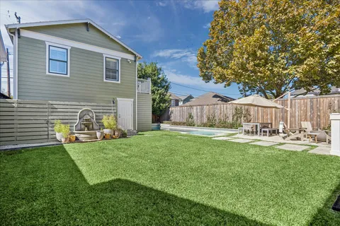 a view of a house with a yard and sitting area