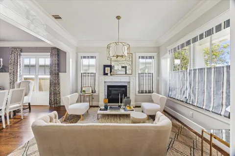 a living room with furniture a fireplace and a large window