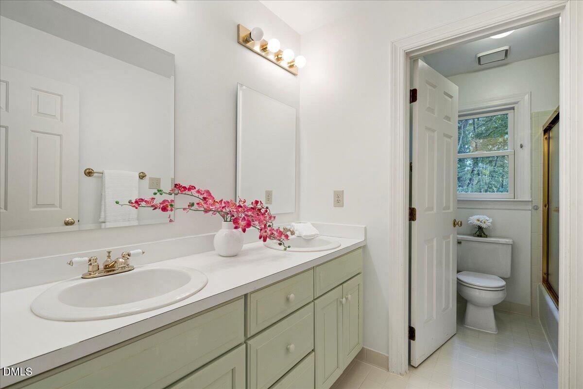 7029 Spring Ridge Road Cary, NC 27518 - Photo 23 of 39 Secondary full bath, with dual sinks and private showering area.