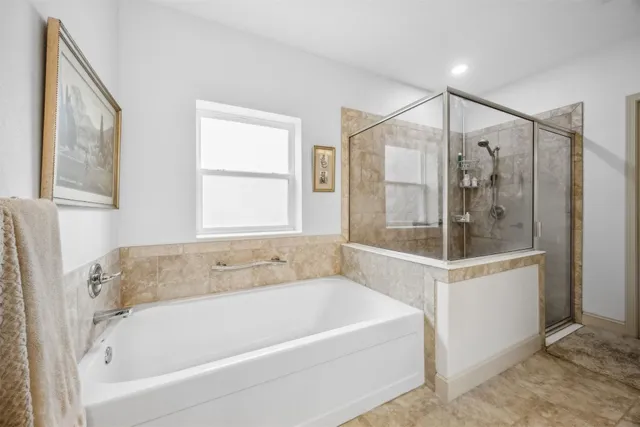 a white bath tub sitting next to a shower