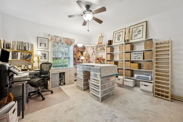 a view of a workspace with furniture and a bookshelf