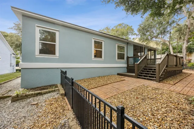 a view of house with backyard and trees