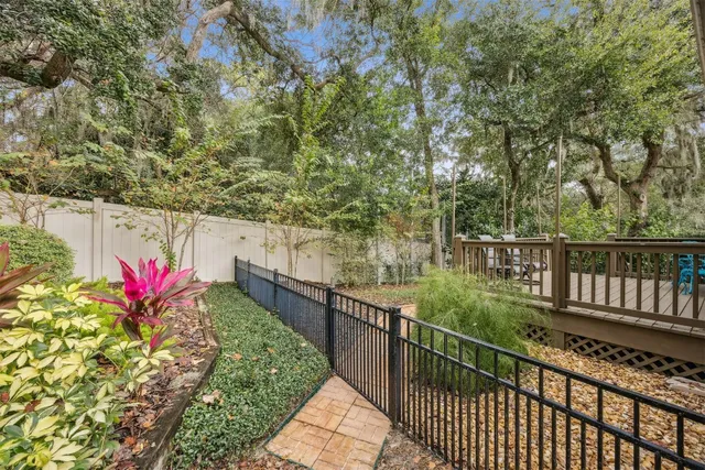 a view of a pathway next to a yard