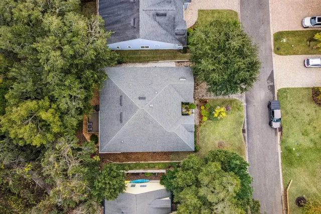 an aerial view of a house with a yard