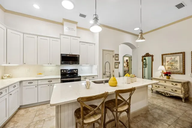 a large kitchen with a table and chairs