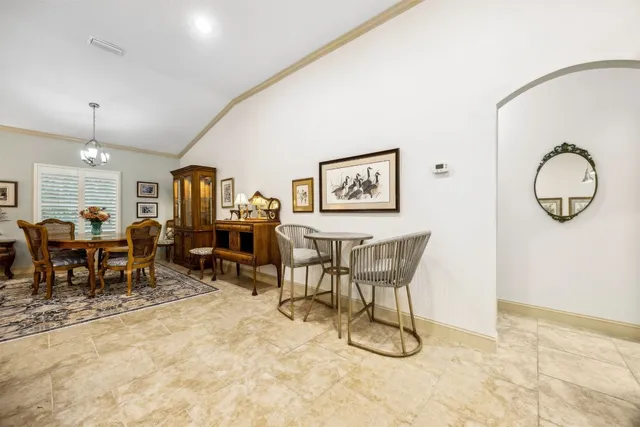 a living room with furniture a dining table and a painting on the wall