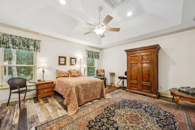 a bedroom with a bed and wooden floor