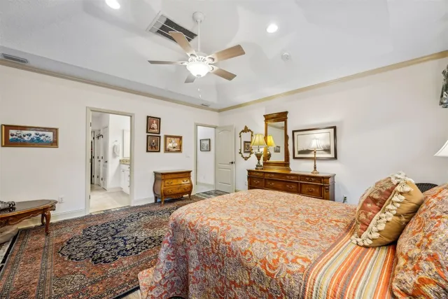 a bedroom with a large bed and a chandelier