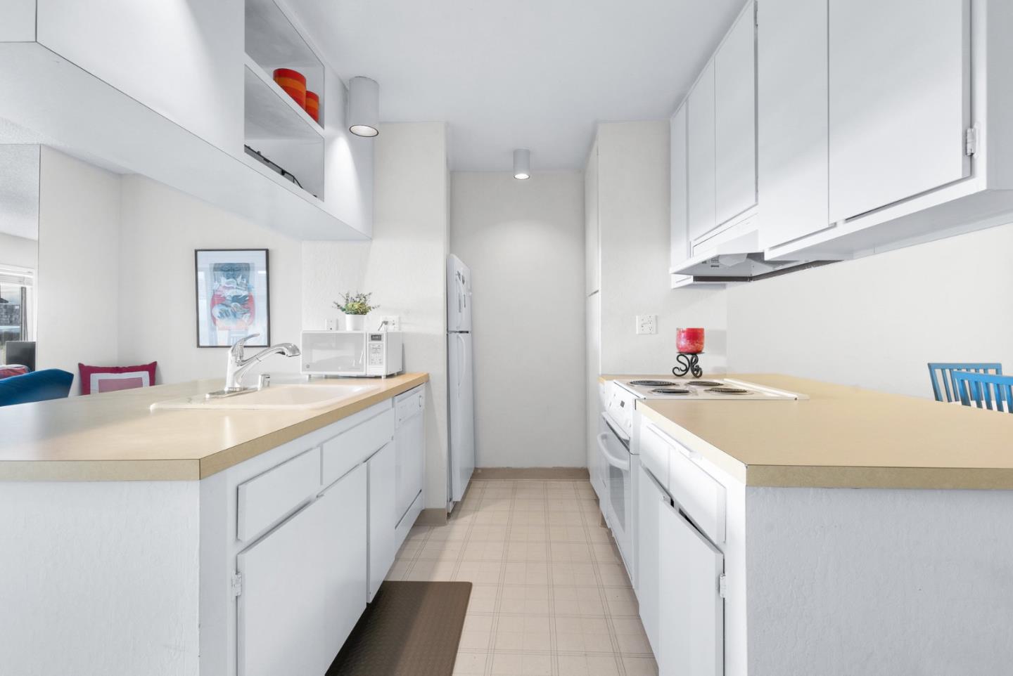 101 Shell Road, Unit 244 Watsonville, CA 95076 - Photo 13 of 32 a kitchen with granite countertop a sink and white cabinets