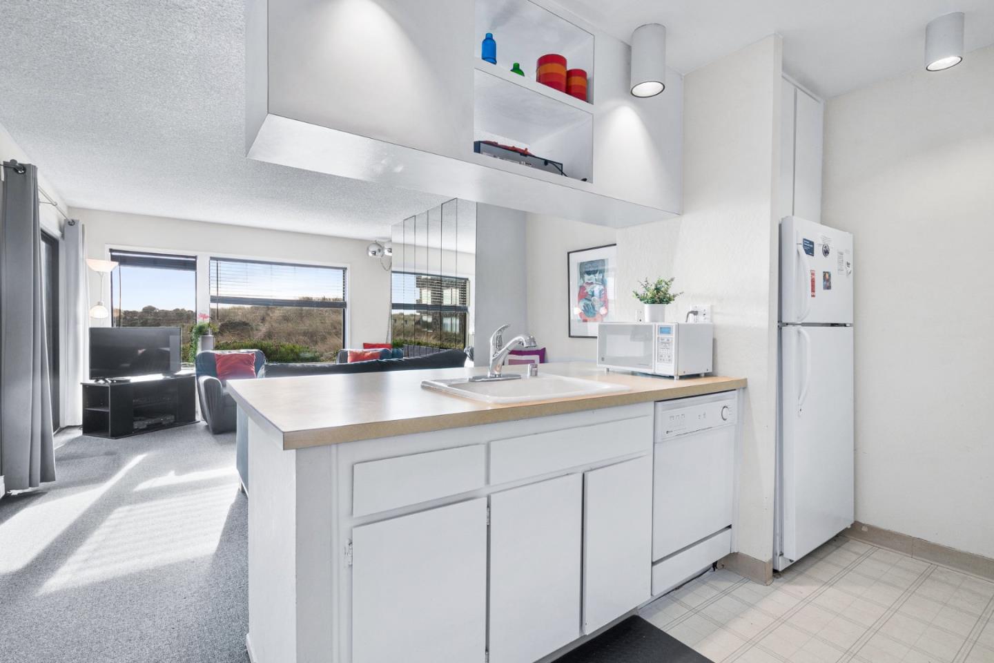 101 Shell Road, Unit 244 Watsonville, CA 95076 - Photo 14 of 32 a kitchen with white cabinets and sink