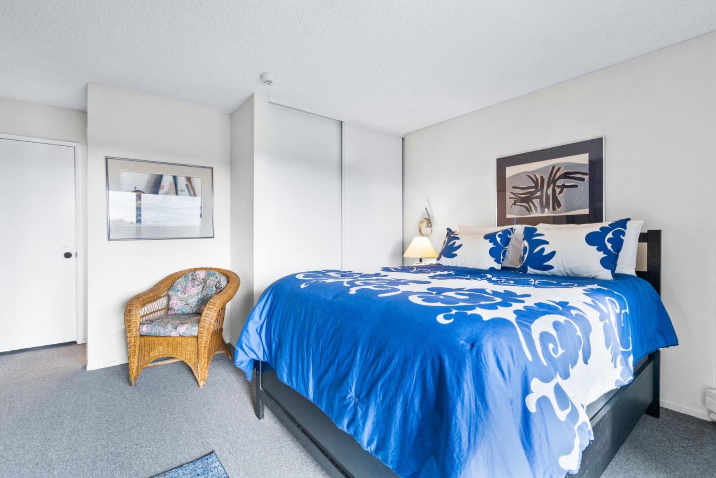 101 Shell Road, Unit 244 Watsonville, CA 95076 - Photo 17 of 32 a bedroom with a bed and a lamp on dresser