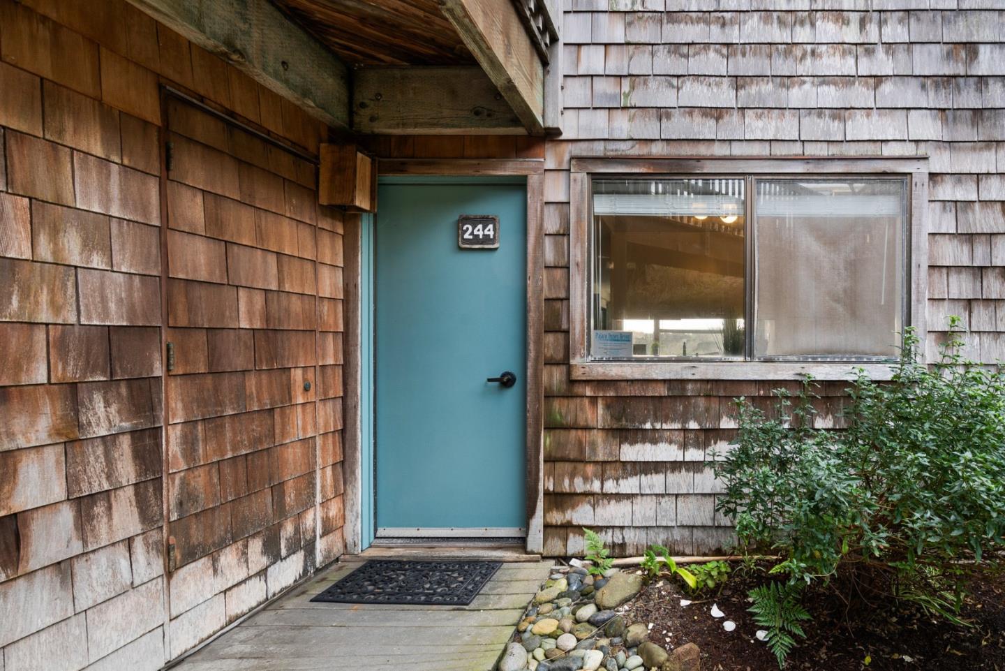 101 Shell Road, Unit 244 Watsonville, CA 95076 - Photo 2 of 32 a front view of a building with a garden