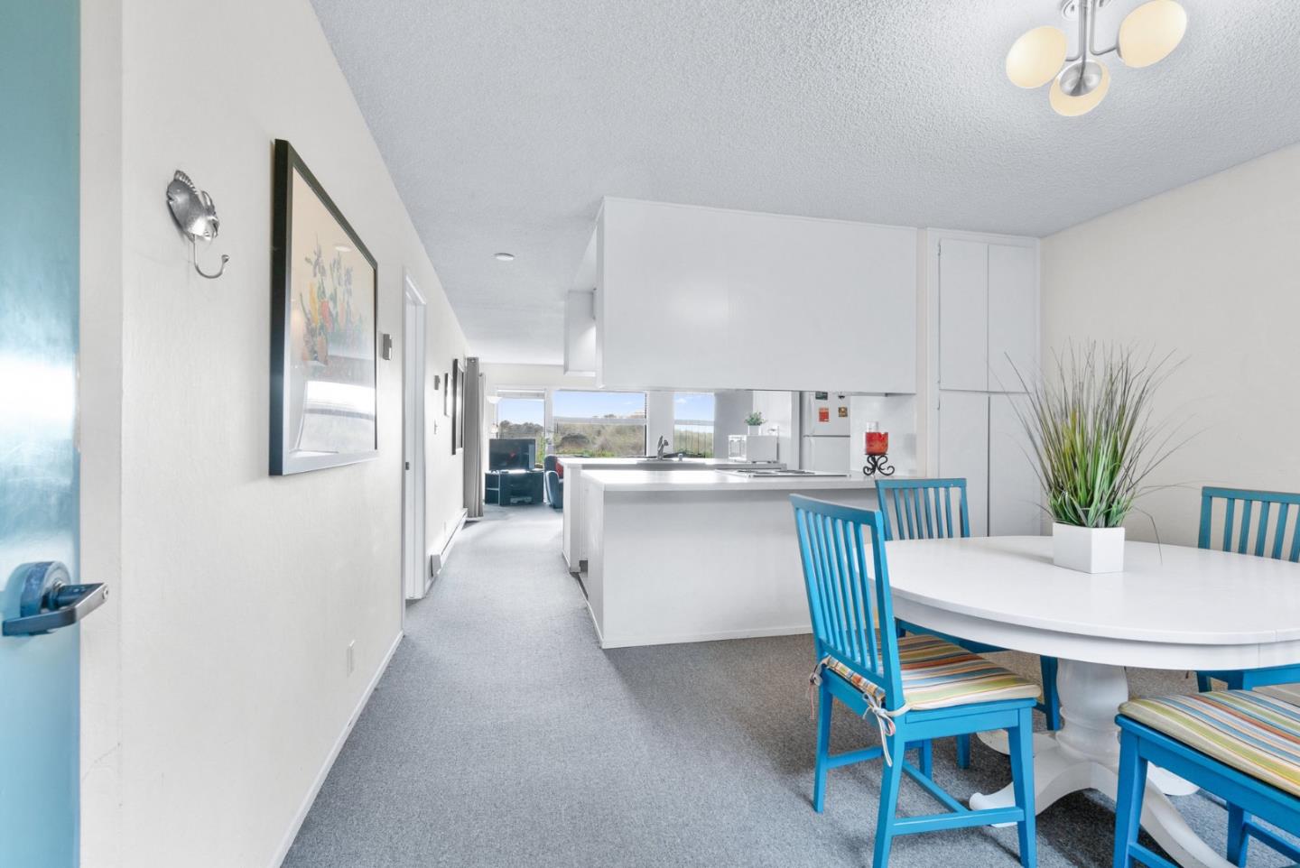 101 Shell Road, Unit 244 Watsonville, CA 95076 - Photo 3 of 32 a kitchen with refrigerator cabinets and dining table