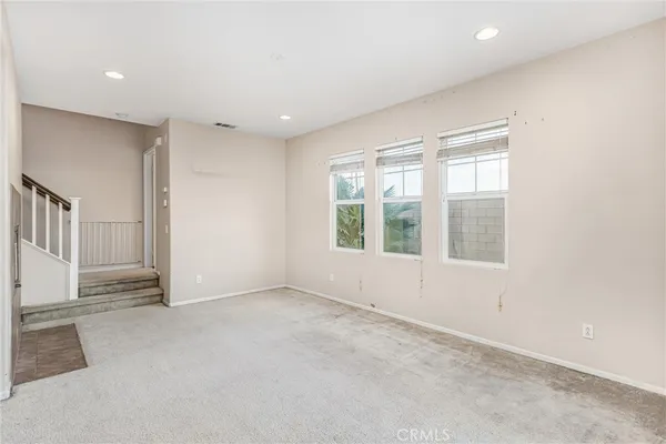 a view of a livingroom with an empty space and fireplace