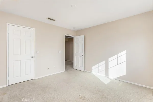 an empty room with windows and closet